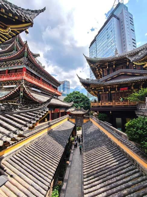 Chongqing: Trendy Spots, Cableway & Ferry Private Tour - Luohan Temple between skyscrapers: incense, stone faces, and calm