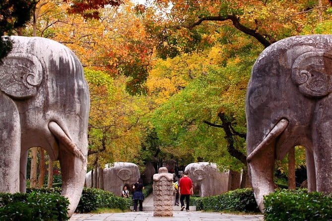 Private Day Tour to Niushoushan Cultural Park in Nanjing - Usnisa Pagoda and monastery details with gold and painted saints